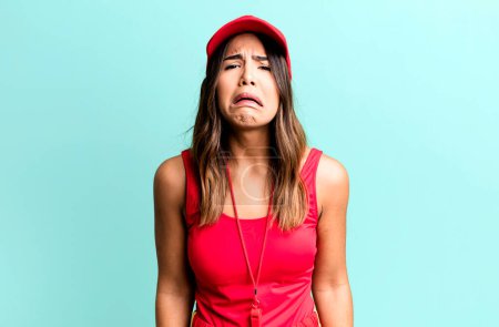 Photo for Hispanic pretty woman feeling sad and whiney with an unhappy look and crying sport coach concept - Royalty Free Image
