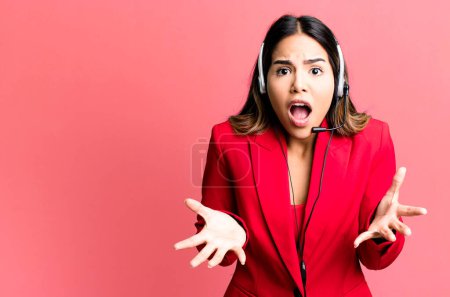 Photo for Hispanic pretty woman amazed, shocked and astonished with an unbelievable surprise. telemarketing concept - Royalty Free Image