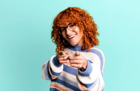 Photo for Redhair pretty woman feeling happy, cool, satisfied, relaxed and successful, pointing at camera, choosing you - Royalty Free Image