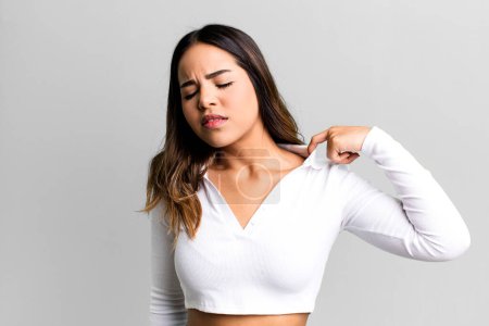 Photo for Hispanic pretty woman feeling stressed, anxious, tired and frustrated, pulling shirt neck, looking frustrated with problem - Royalty Free Image