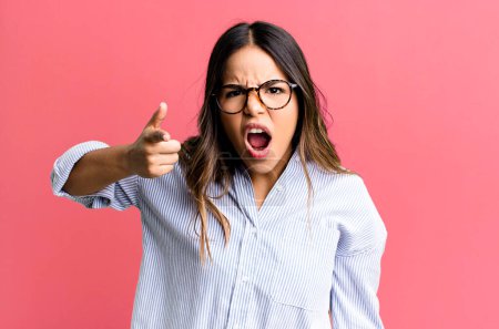 Photo for Hispanic pretty woman pointing at camera with an angry aggressive expression looking like a furious, crazy boss - Royalty Free Image