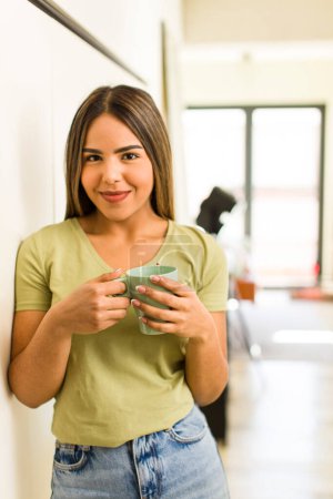Foto de Pretty latin woman having a coffee cup at home. - Imagen libre de derechos