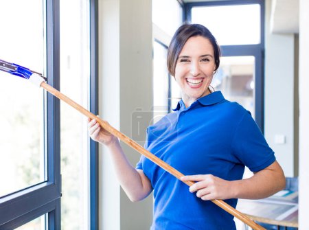 Téléchargez les photos : Young adult windows washer concept. cleaning house interior - en image libre de droit