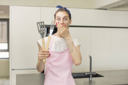 Photo for Covering mouth with a hand and shocked or surprised expression. Barbecue tools concept - Royalty Free Image