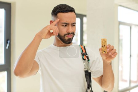 Photo for Arab handsome man arab man looking surprised, realizing a new thought, idea or concept.  fitness and cereal bar concept - Royalty Free Image