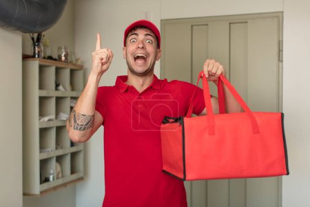 Photo for Young handsome man feeling like a happy and excited genius after realizing an idea. pizza delivery concept - Royalty Free Image