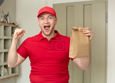 Photo for Feeling shocked,laughing and celebrating success. delivery paper bag concept - Royalty Free Image