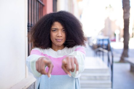 Photo for African american pretty woman pointing forward at camera with both fingers and angry expression, telling you to do your duty - Royalty Free Image