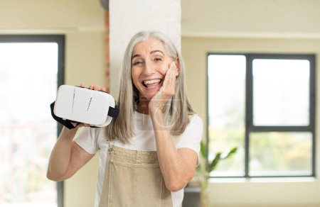 Photo for Pretty senior woman feeling happy and astonished at something unbelievable. with vr goggles - Royalty Free Image