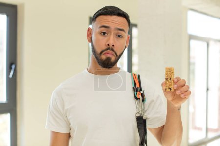 Photo for Arab handsome man arab man feeling sad and whiney with an unhappy look and crying.  fitness and cereal bar concept - Royalty Free Image