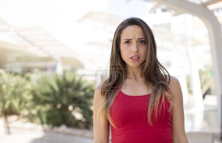 Photo for Pretty woman feeling terrified and shocked, with mouth wide open in surprise - Royalty Free Image