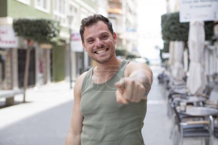 Photo for Handsome man pointing at camera with a satisfied, confident, friendly smile, choosing you - Royalty Free Image