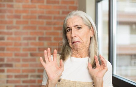 Photo for Senior pretty woman feeling disgusted and irritated, sticking tongue out, disliking something nasty and yucky - Royalty Free Image