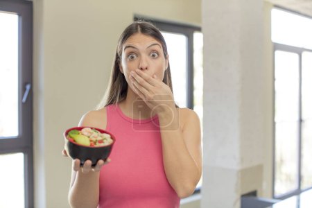 Photo for Young pretty woman covering mouth with a hand and shocked or surprised expression. japanese ramen concept - Royalty Free Image