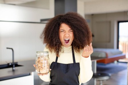 Photo for Pretty afro black woman looking angry, annoyed and frustrated. homemade cookies concept - Royalty Free Image