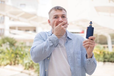 Photo for Covering mouth with a hand and shocked or surprised expression. vaper concept - Royalty Free Image