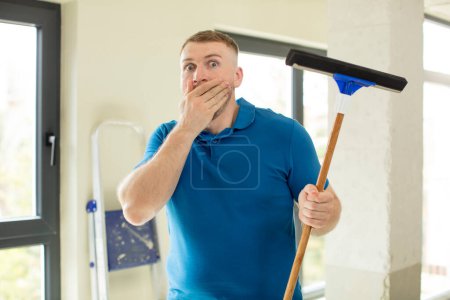 Photo for Covering mouth with a hand and shocked or surprised expression. windows washer - Royalty Free Image