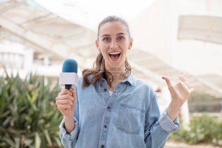 Photo for Feeling happy and astonished at something unbelievable. presenter with a microphone concept - Royalty Free Image