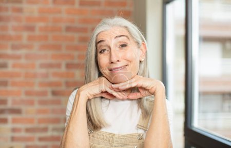 Téléchargez les photos : Senior jolie femme se sentant réfléchi, se demandant ou imaginant des idées, rêvant et regardant vers le haut pour copier l'espace - en image libre de droit