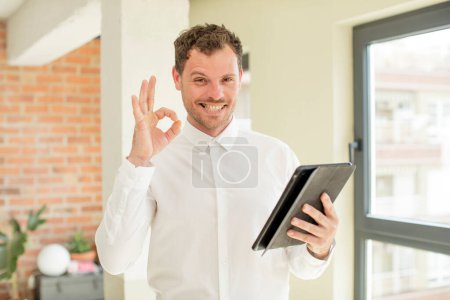 Photo for Feeling happy, showing approval with okay gesture. touch screen concept - Royalty Free Image