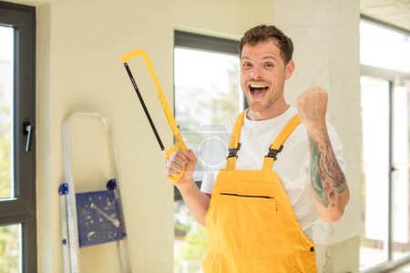 Photo for Feeling shocked,laughing and celebrating success. handyman saw concept - Royalty Free Image