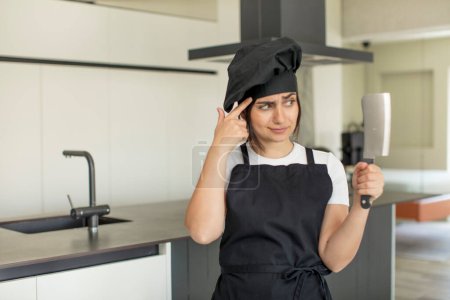 Photo for Young woman looking surprised, realizing a new thought, idea or concept. chef concept - Royalty Free Image
