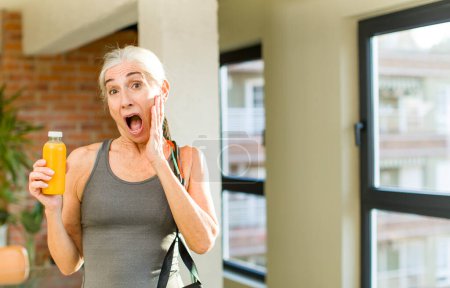 Photo for Pretty senior woman feeling happy and astonished at something unbelievable. fitness concept - Royalty Free Image