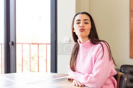 Photo for Pretty caucasian woman pressing lips together with a cute, fun, happy, lovely expression, sending a kiss - Royalty Free Image