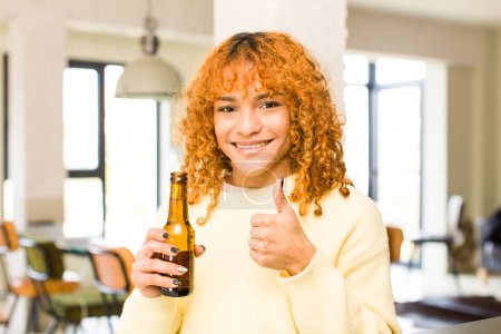 Photo for Young red hair latin pretty woman having a beer at home - Royalty Free Image