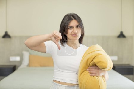Photo for Young woman feeling cross,showing thumbs down. nightwear concept - Royalty Free Image