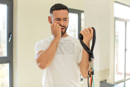 Photo for Arab handsome man arab man feeling scared, worried or angry and looking to the side. fitness concept - Royalty Free Image