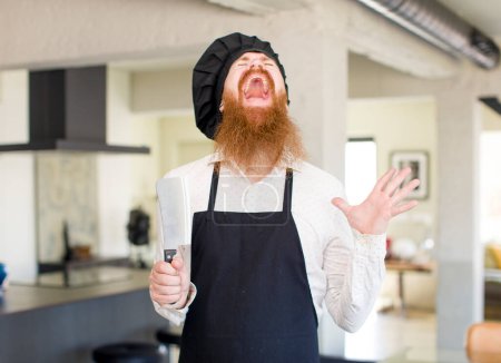 Photo for Red hair man screaming with hands up in the air. chef concept - Royalty Free Image