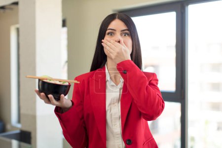 Photo for Pretty young woman covering mouth with a hand and shocked or surprised expression. japanese ramen bowl concept - Royalty Free Image