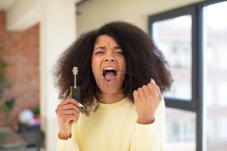 Photo for Pretty afro black woman looking angry, annoyed and frustrated. new home key concept - Royalty Free Image