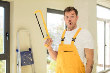 Photo for Feeling extremely shocked and surprised. handyman saw concept - Royalty Free Image