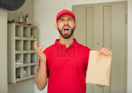 Photo for Young  adult man screaming with hands up in the air. deliveryman concept - Royalty Free Image