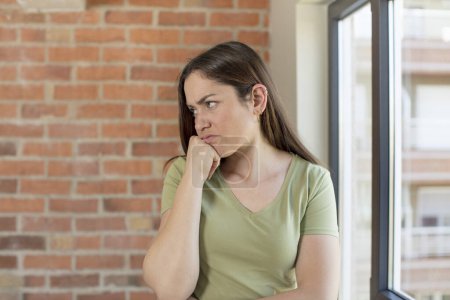 Photo for Young adult pretty woman feeling sad and stressed, upset because of a bad surprise, with a negative, anxious look - Royalty Free Image