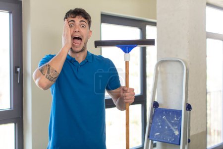 Photo for Young handsome man feeling happy and astonished at something unbelievable. windows washer concept - Royalty Free Image