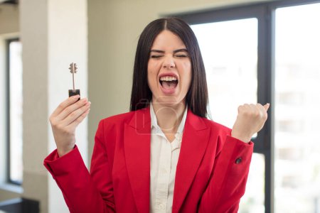 Photo for Pretty young woman looking angry, annoyed and frustrated. new home key concept - Royalty Free Image