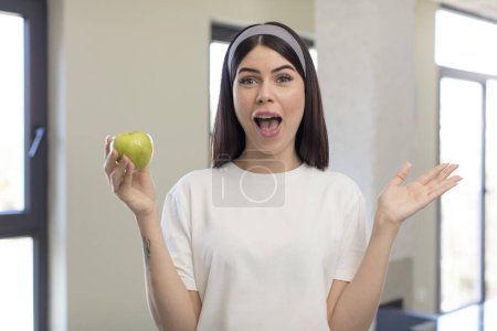 Photo for Pretty young woman feeling happy and astonished at something unbelievable. apple concept - Royalty Free Image