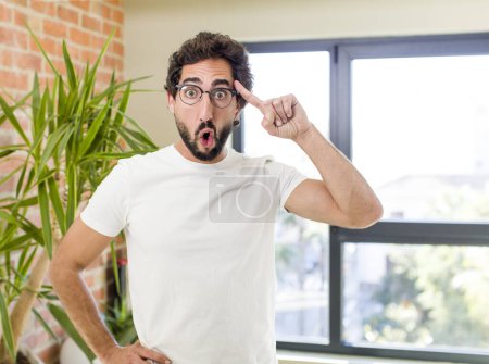 Photo for Young adult crazy man with expressive pose at a modern house interior - Royalty Free Image