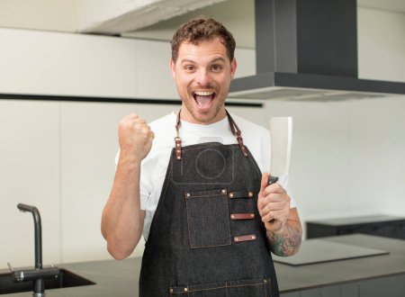 Photo for Feeling shocked,laughing and celebrating success. chef at home - Royalty Free Image