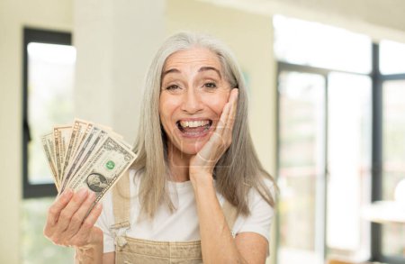 Photo for Pretty senior woman feeling happy and astonished at something unbelievable. with dollar banknotes - Royalty Free Image
