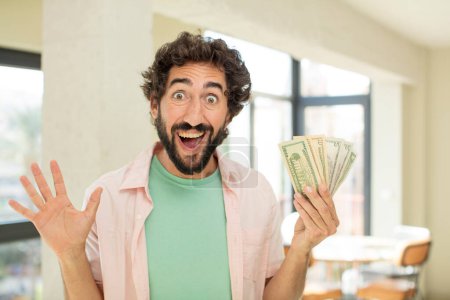 Photo for Crazy bearded man feeling happy and astonished at something unbelievable. dollar banknotes concept - Royalty Free Image