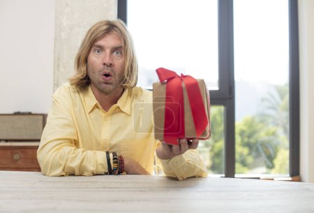 Photo for Young adult caucasian man feeling extremely shocked and surprised. gift concept - Royalty Free Image