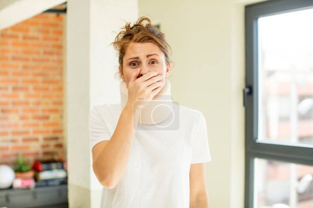 Photo for Young pretty woman covering mouth with a hand and shocked or surprised expression. accident collar concept - Royalty Free Image