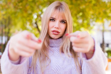 Photo for Young pretty woman pointing forward at camera with both fingers and angry expression, telling you to do your duty - Royalty Free Image