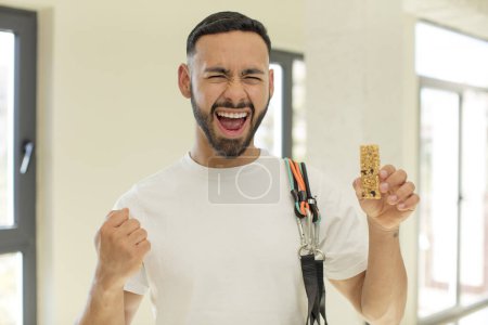 Photo for Arab handsome man arab man looking angry, annoyed and frustrated.  fitness and cereal bar concept - Royalty Free Image