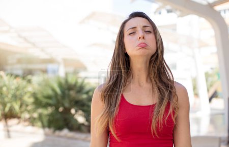 Photo for Pretty woman feeling sad and whiney with an unhappy look, crying with a negative and frustrated attitude - Royalty Free Image