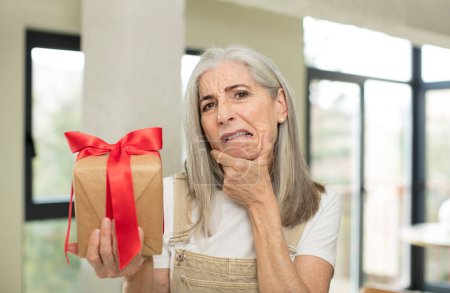 Photo for Senior woman holding a gift box - Royalty Free Image